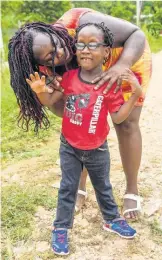  ??  ?? Shanice Rowe poses with her son, Lashaun Rowe, in Zambia, Central Village, St Catherine. Lashaun suffers from a rare medical condition, WalkerWarb­urg Syndrome, a rare multisyste­m disorder that tends to claim the lives of children by age three. Lashaun celebrates his sixth birthday this Saturday.