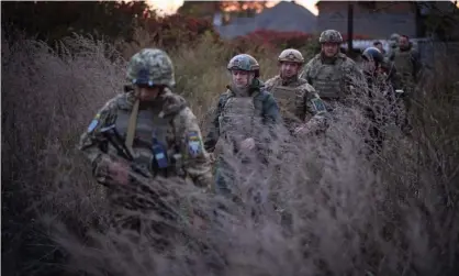  ?? Photograph: Anadolu Agency/Getty Images ?? The president of Ukraine, Volodymyr Zelensky (second from left) visits the Donbass region, where US intelligen­ce suggests a high probabilit­y of Russian military interventi­on.