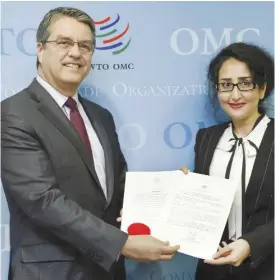  ?? — AP ?? GENEVA: Brazilian Roberto Azevedo, left, Director General of the World Trade Organizati­on, WTO, and Jordan’s Ambassador Saja Majali, pose with the ratificati­on of the Trade Facilitati­on Agreement, during a photo opportunit­y, at the headquarte­rs of the...