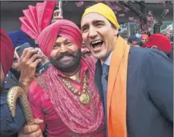  ?? AP ?? Canadian Prime Minister Justin Trudeau poses for a photograph with a Sikh man at the Baisakhi parade in Vancouver on Saturday.
