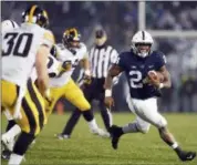  ?? CHRIS KNIGHT — THE ASSOCIATED PRESS ?? Penn State running back Miles Sanders (24) carries the ball against Iowa during the second half of Saturday’s game in State College. Penn State won 30-24.