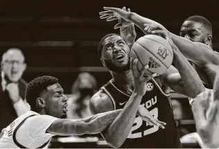  ?? Sam Craft / Associated Press ?? Texas A&M guard Jay Jay Chandler fouls Missouri forward Jeremiah Tilmon, who had 14 points and 10 rebounds, during the Tigers’ road victory at Reed Arena in College Station on Saturday.