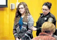  ?? MICHAEL SEARS/MILWAUKEE JOURNAL-SENTINEL ?? Anissa Weier, one of two Wisconsin girls who tried to kill a classmate to win favour with a fictional horror character named Slender Man, is led into the Waukesha County Court for her sentencing hearing, Thursday, Dec. 21, 2017, in Waukesha, Wis. She...
