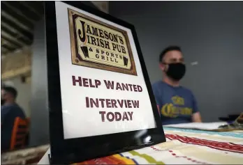  ?? MARCIO JOSE SANCHEZ — THE ASSOCIATED PRESS FILE ?? A hiring sign is placed at a booth for Jameson’s Irish Pub during a job fair in the West Hollywood section of Los Angeles.