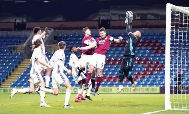  ?? Agence France-presse ?? ↑ Leicester City’s goalkeeper Kasper Schmeichel (right) makes a save during the English Premier League match against Burnley in Burnley on Wednesday.