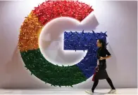  ?? The Associated Press ?? A woman walks past the logo for Google at the China Internatio­nal Import Expo in Shanghai on Nov. 5, 2018. Google said Friday it will let people request that additional types of informatio­n such as personal contact informatio­n like phone numbers, email and physical addresses be removed from search results.