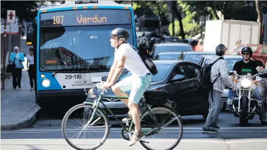  ?? PHOTOS: ALLEN McINNIS ?? A motorist wedges his car in front of a bus to turn onto Sherbrooke St. Monday. Montreal aims to reduce to zero the number of deaths and serious injuries on its roads.