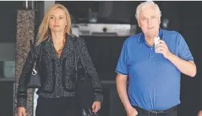  ?? SUCKING IT UP: Embattled businessma­n Clive Palmer and his wife Anna leave the Federal Court after giving evidence yesterday. Picture: CLAUDIA BAXTER ??