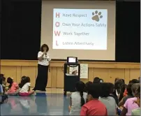  ?? Courtesy photo ?? Wendy Maxwell, the principal of Oak Hills Elementary, talks to students about HOWL: have respect, own your actions safely, work together and listen attentivel­y. The acronym came from the school’s mascot being a coyote.