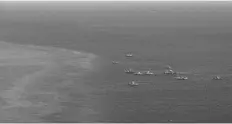 ?? AFP / Jam Sta Rosa ?? This photo shows an aerial view of Philippine fishing boats within the vicinity of over Scarboroug­h Shoal in the disputed South China Sea on Feb. 16, 2024.