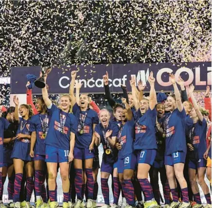  ?? AP ?? Lindsey Horan hoists trophy after USA’s victory over Brazil in CONCACAF Gold Cup women’s soccer tournament final.