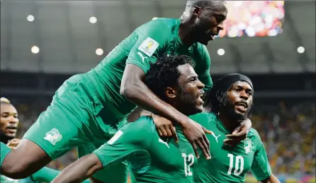  ?? PICTURE: GETTY IMAGES ?? THAT WINNING FEELING: Ivory Coast must at least draw against group winners Cameroon today if they are to secure their spot in Equatorial Guinea next year. Here Wilfried Bony, centre, celebrates with captain Yaya Toure, left, and Gervinho after scoring...