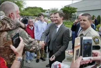  ?? CHUCK BURTON — THE ASSOCIATED PRESS ?? Dale Earnhardt Jr., center, greets fans after a news conference at Hendrick Motorsport­s in Concord, N.C., Tuesday.