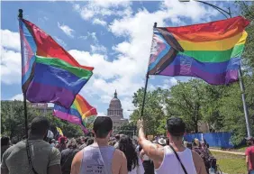  ?? AARON E. MARTINEZ/USA TODAY NETWORK ?? Activists waving Pride flags participat­e with hundreds of others in the Queer Capitol March on April 15, 2023, in Austin, Texas, to protest anti-LGBTQ+ legislatio­n in the state.