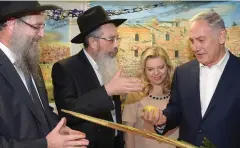  ?? (Facebook) ?? PRIME MINISTER Benjamin Netanyahu holds an etrog and lulav during an ‘open sukka’ event at his Jerusalem residence last year.