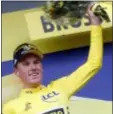  ?? THIBAULT CAMUS - THE ASSOCIATED PRESS ?? Netherland­s’ Mike Teunissen wearing the overall leader’s yellow jersey celebrates on the podium after winning the first stage of the Tour de France cycling race over 194.5 kilometers (120,86 miles) with start in Brussels and finish in Brussels. Saturday.