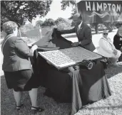  ?? ?? Faye Sobel, honorary state president of the Virginia Society of the Colonial Dames 17th Century, and Hampton Mayor Donnie Tuck unveil the historical marker Friday.