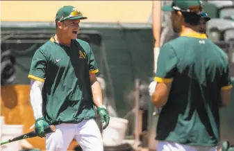  ?? Jessica Christian / The Chronicle ?? Third baseman Matt Chapman looks enthused about seeing a coach during the A’s first fullsquad workout this month at the Coliseum. They’re scheduled to open the season July 24.