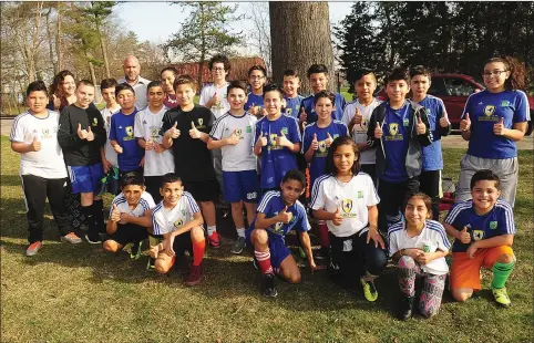  ?? Photo by Ernest A. Brown ?? Darius Shirzadi (above, back left) joins Nikhol Bentley and Rosaura Vazquez, and Project GOAL youngsters at Moses Brown last week. Six Bryant students teamed up with Project GOAL, which helps disadvanta­ged youth in the area through soccer, to help...