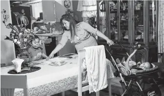  ?? Marie D. De Jesús / Staff photograph­er ?? Maria Guadalupe Juarez, 28, helps her daughter Brianna, 7, with homework while tending to her 10-month-old son, Isaac, at home in Pearland. Juarez is one of the thousands of immigrants protected by DACA and says she’s anguished at the thought of being deported.