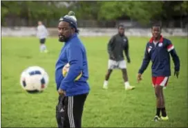  ?? RICK KAUFFMAN — DIGITAL FIRST MEDIA ?? Bobby Ali, left, co-founder of the Junior Lone Star soccer team set to make its U.S. Open Cup debut Wednesday, watches a recent practice at Penn Wood Middle School.