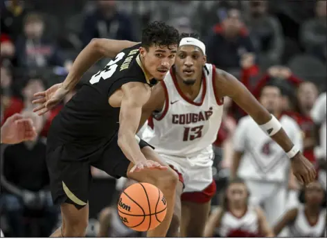  ?? AARON ONTIVEROZ — THE DENVER POST ?? Tristan da Silva (23) of the Colorado Buffaloes runs in transition ahead of Isaac Jones (13) of the Washington State Cougars at T-mobile Arena in Las Vegas, Nevada on Friday.