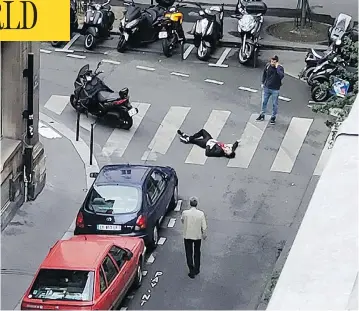  ?? WLADIA DRUMMOND VIA THE ASSOCIATED PRESS ?? A man lays on a street in central Paris Saturday after a stabbing rampage by a 20-year-old Chechen-born man, who was fatally shot by police. The killer was on a police watchlist for radicalism but had a clean criminal record.