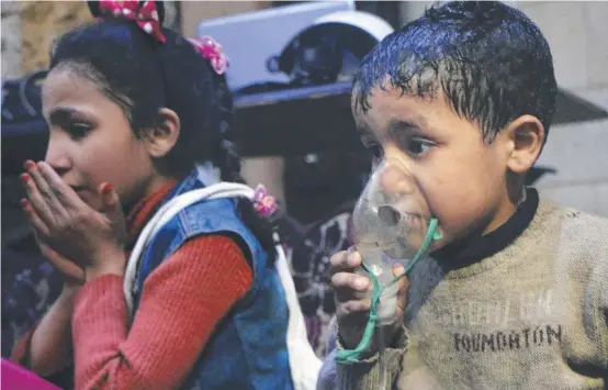  ?? SURVIVOR: A child receives oxygen through a respirator following an alleged poison gas attack in the rebel- held town of Douma, near Damascus, Syria. ??