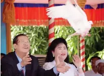  ??  ?? Cambodia's Prime Minister and President of the Cambodian People's Party (CPP) Hun Sen and his wife Bun Rany release pigeons during a CPP ceremony marking the 39th anniversar­y of the fall of the Khmer Rouge regime in Phnom Penh on Sunday. (AFP)