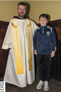  ?? Photo by John Reidy ?? Fr. Bryan Shortall pictured with ‘Miracle Baby’ 11-year-old Jayden Foleyfrom Farranfore at the first Padre Pio, Tuesday night novena at the Church of Saints Stephen and John.