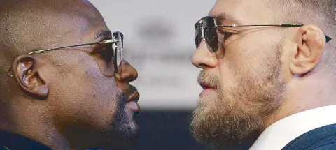  ?? AP ?? Floyd Mayweather Jr., left, and Conor McGregor come face-to-face during a news conference in Las Vegas. The two are scheduled to fight Saturday.