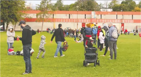  ?? JEAN LEVAC ?? Families face long lineups for COVID-19 testing at Brewer Park on Tuesday as the province struggles to keep up with growing demand.