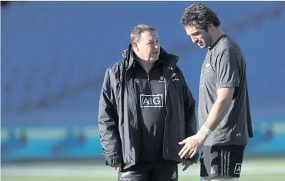  ??  ?? New Zealand coach Steve Hansen, left, talks to captain Sam Whitelock during training.