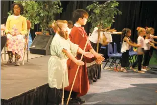  ??  ?? Moses and his brother Aaron, played by Donoval Randall and Andrew Ramos, visit plagues upon the Egyptians in Potomac Heights Christian Academy’s final spring musical for elementary and middle school students.