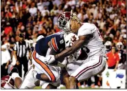  ?? AP/BUTCH DILL ?? Alabama defensive back Xavier McKinney (15) loses his helmet as Auburn running back Shaun Shivers (8) runs through him for a touchdown Saturday during the second half of an NCAA game in Auburn, Ala.