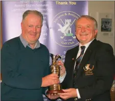  ??  ?? Patrick Cannon, winner of the Joe Moore Trophy (sponsored by Raymond Moore, Hibernia Steel Products Ltd) and the outright winner of the Senior Hampers event (sponsored by Dr Harry Barry) is presented with his prize Captain Bryan Collins.