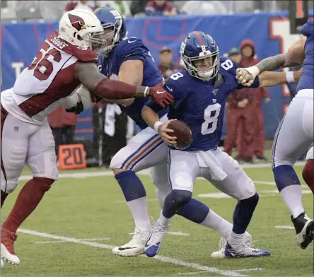  ?? BILL KOSTROUN - THE ASSOCIATED PRESS ?? New York Giants quarterbac­k Daniel Jones, center, tries to evade the Arizona Cardinals defense during the second half of an NFL football game, Sunday, Oct. 20, 2019, in East Rutherford, N.J.