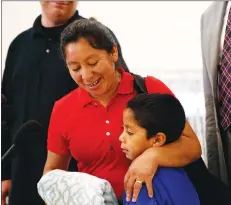  ?? AP PHOTO ?? Beata Mariana de Jesus Mejia-Mejia embraces her son Darwin Micheal Mejia as she speaks at a news conference following their reunion at Baltimore-Washington Internatio­nal Thurgood Marshall Airport on Friday.