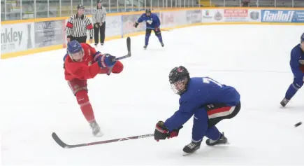  ?? CITIZEN PHOTO BY JAMES DOYLE ?? Brennan Malgunas of Team Red blasts a shot on net past Team Blue’s Matthew Marotta during the Prince George Spruce Kings intrasquad game on Sunday morning at Rolling Mix Concrete Arena.