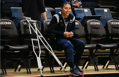  ?? Jessica Hill/Associated Press ?? UConn’s Azzi Fudd watches her team warm up as she sits out with a knee injury before a game against Butler on Jan. 21, 2023, in Storrs.