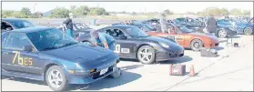  ?? Keith Bryant/The Weekly Vista ?? Cars line up in the grid area and drivers prepare themselves and their vehicles before the first heat starts.