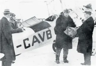  ??  ?? Bush pilot Wilfrid “Wop” May receives diphtheria medication from Alberta’s deputy health minister Dr. Malcolm Bow for his daring 1929 mercy mission to stem an outbreak in Fort Vermilion.