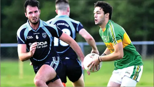  ??  ?? Johnny Kelly of Tourlestra­ne sets up another attack as Oisin Cox moves in to tackle. Pic: Tom Callanan.