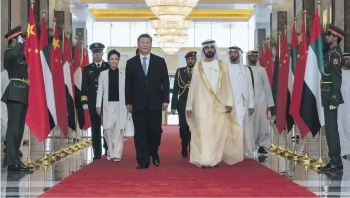  ?? Hamad Al Kaabi / Crown Prince Court – Abu Dhabi ?? Sheikh Mohammed bin Rashid, Vice President and Ruler of Dubai, and Sheikh Mohammed bin Zayed, Crown Prince of Abu Dhabi and Deputy Supreme Commander of the Armed Forces, receive President Xi Jinping of China and his wife, Peng Liyuan, at the Presidenti­al Airport in Abu Dhabi on Thursday at the start of a three-day state visit