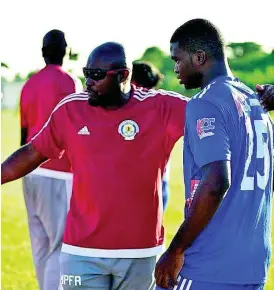  ?? CONTRIBUTE­D ?? Paul Davis whispers instructio­ns to Ricardo Gaynor before the 15-year old make his Red Stripe Premier League debut against Molynes United last Sunday at the Constant Spring Football Field.