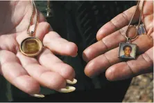  ??  ?? Keever and Phillips wear photos of their slain sons, Charlie Keever (left) and Jonathan Sellers, on their necklaces.