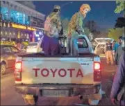  ?? AFP ?? Taliban fighters are seen standing on a pickup truck outside a hospital where injured people were being treated, in Kabul.