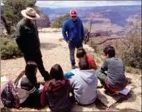  ?? LOANED PHOTO ?? PUEBLO ELEMENTARY STUDENTS sit on the ground as they work on rock identifica­tion at the Grand Canyon during a school trip in May. From left to right are Valeria Hernandez, Mya Lopez, Hugo Ramirez, Alexa Soto, and Leonardo Aguilar. Standing are Ranger...