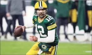 ?? Jeffrey Phelps / Associated Press ?? Green Bay Packers quarterbac­k Aaron Rodgers looks to throw during an NFL divisional playoff football game against the Los Angeles Rams on Jan. 16 in Green Bay, Wis.