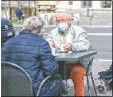  ?? (LaPresse/Cecilia Fabian) ?? People enjoy a coffee at an outdoor cafe in Rome.